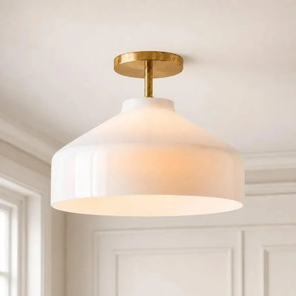 Wide Nordic ceiling light with pale shade and brass hardware