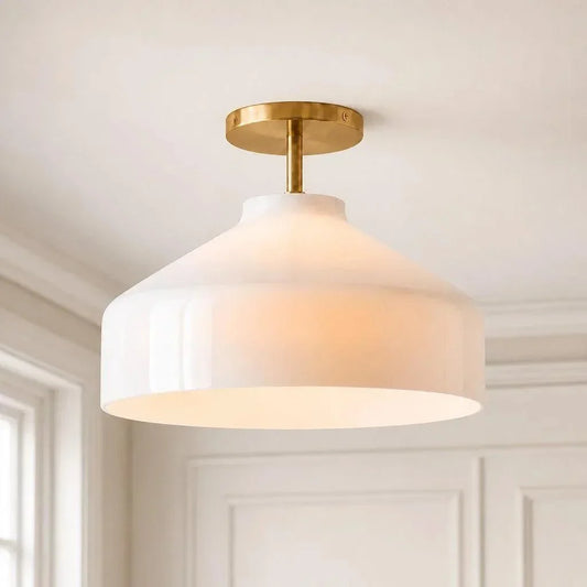 Wide Nordic ceiling light with pale shade and brass hardware