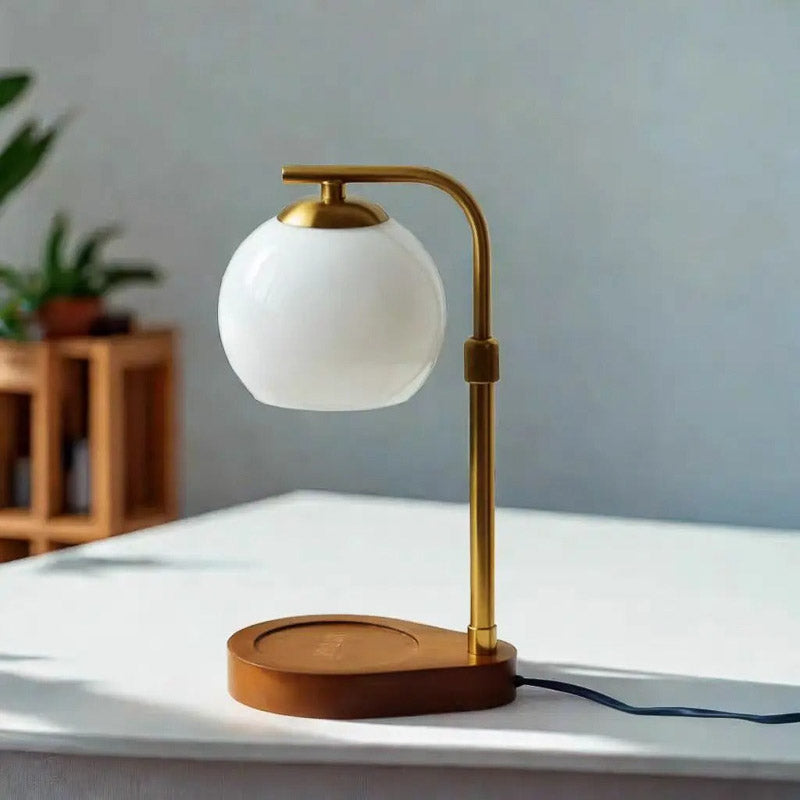 White frosted glass candle warmer lamp with a gold frame and wood base