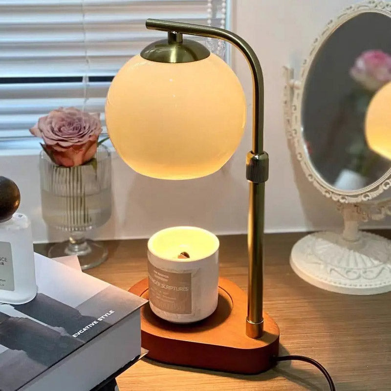 Orange globe candle warmer on a bedside table