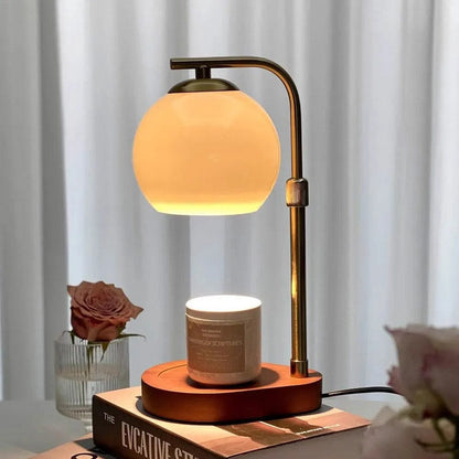 Warm glowing glass candle warmer with a curved gold frame
