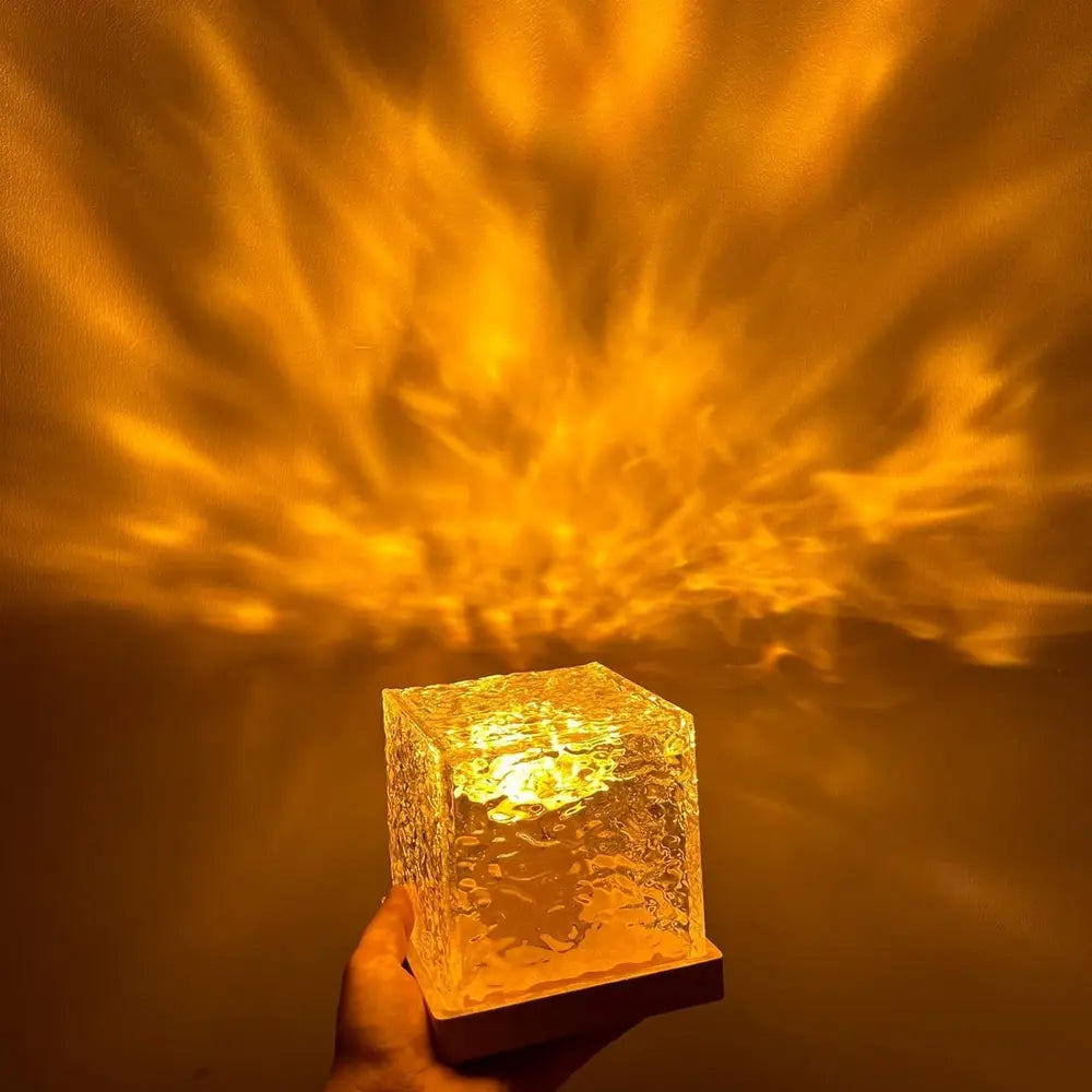Cube mood lamp glowing orange on a wood base