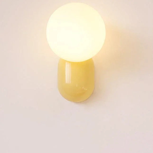 Opal glass globe wall light with yellow resin base