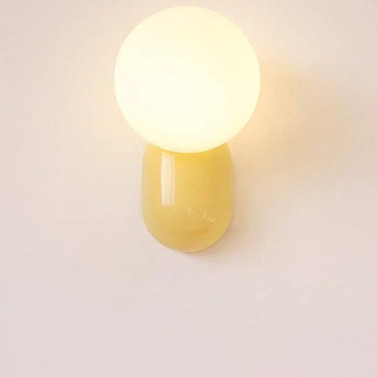 Opal glass globe wall light with yellow resin base