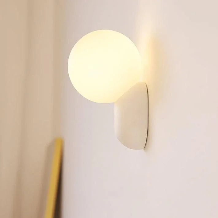 White globe wall light viewed from the side