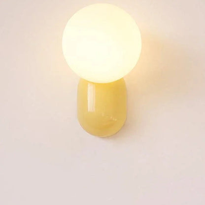 Yellow opal globe wall sconce close-up