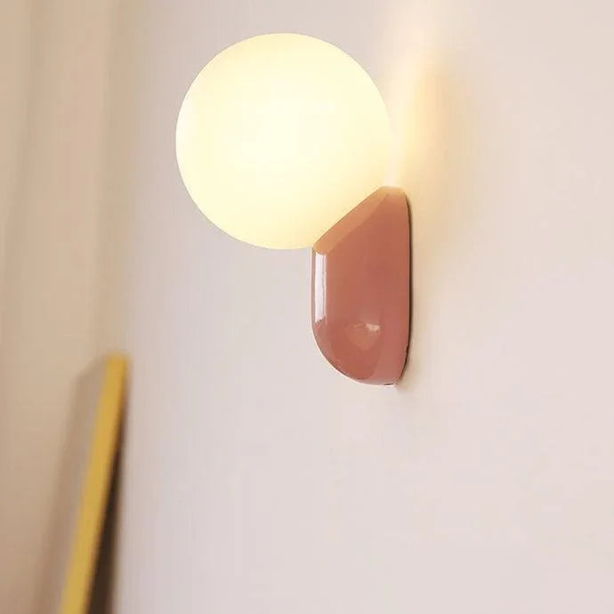 Pink opal globe wall light viewed from the side