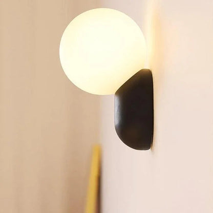 Black globe wall light viewed from the side