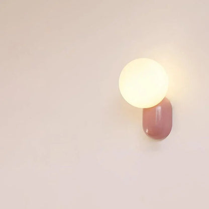 Pink resin base opal globe wall sconce