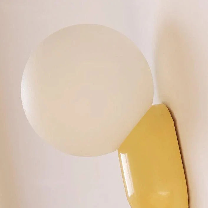 Close-up of opal globe and yellow resin base