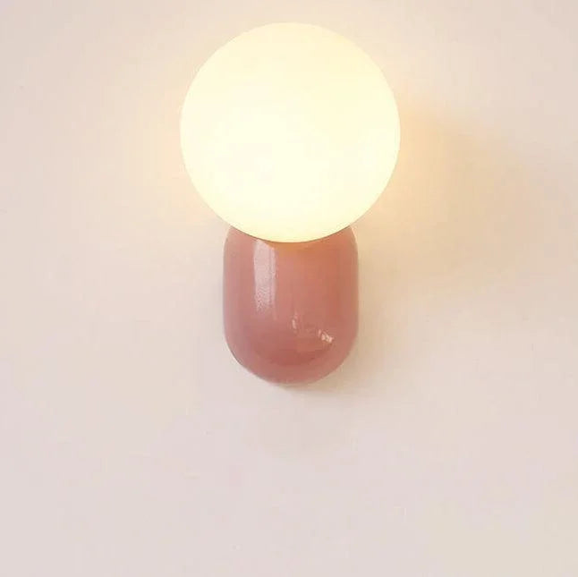 Pink globe wall light viewed from the front