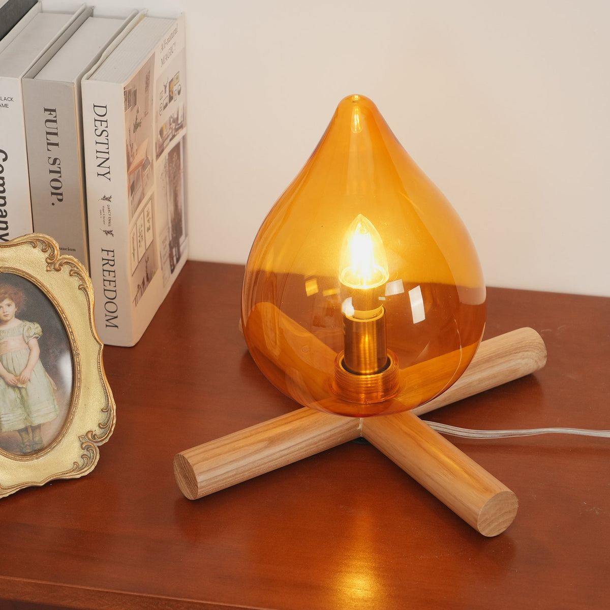 Orange flame-shaped glass table lamp with solid wood cross base 11
