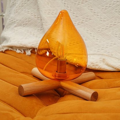 Orange flame-shaped glass table lamp with solid wood cross base 15