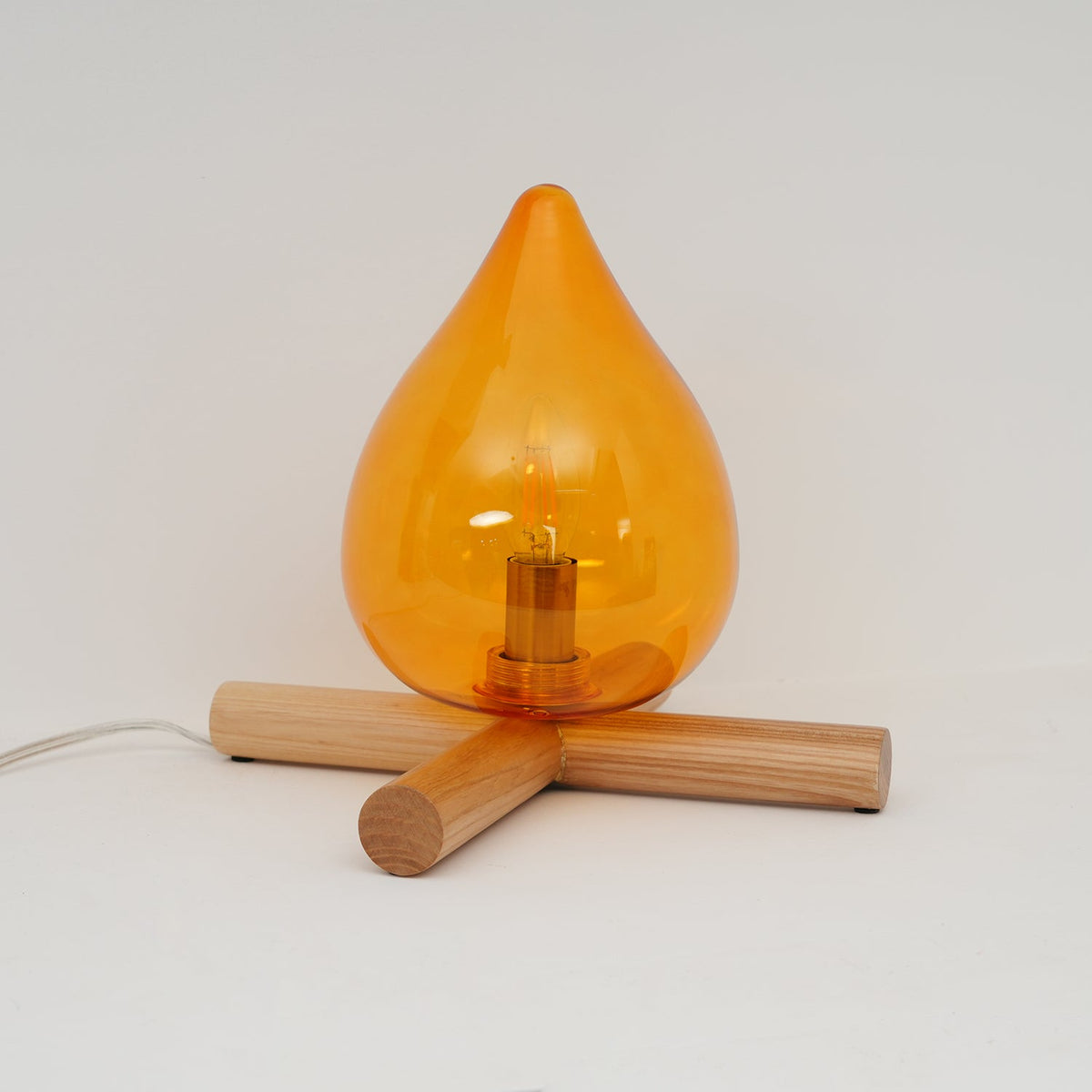 Orange flame-shaped glass table lamp with solid wood cross base 17