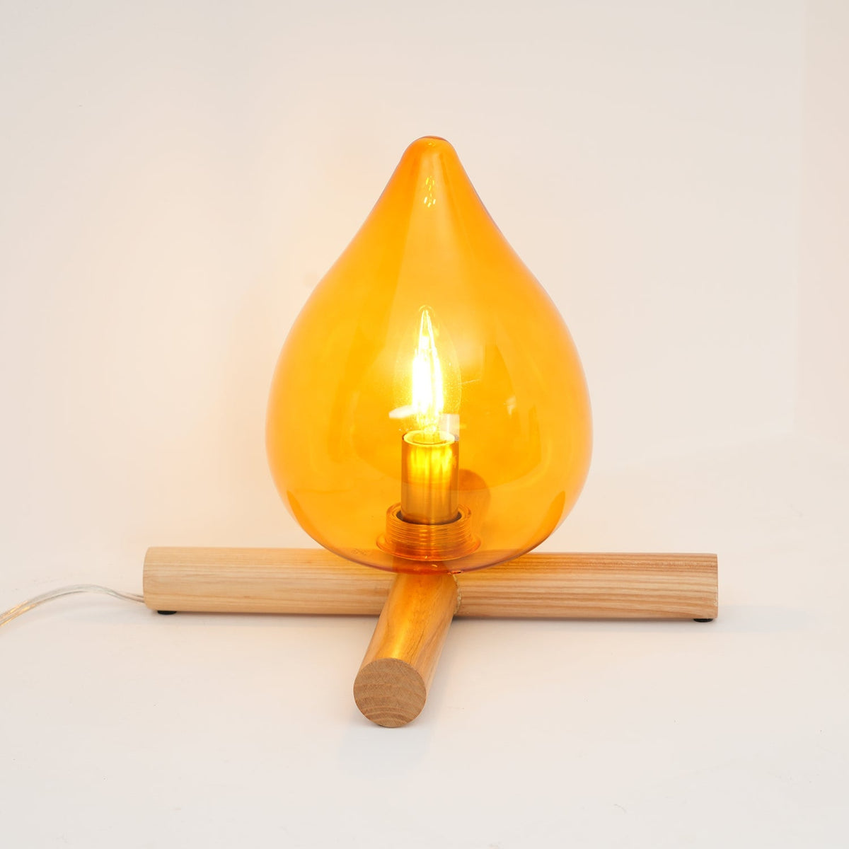 Orange flame-shaped glass table lamp with solid wood cross base 27