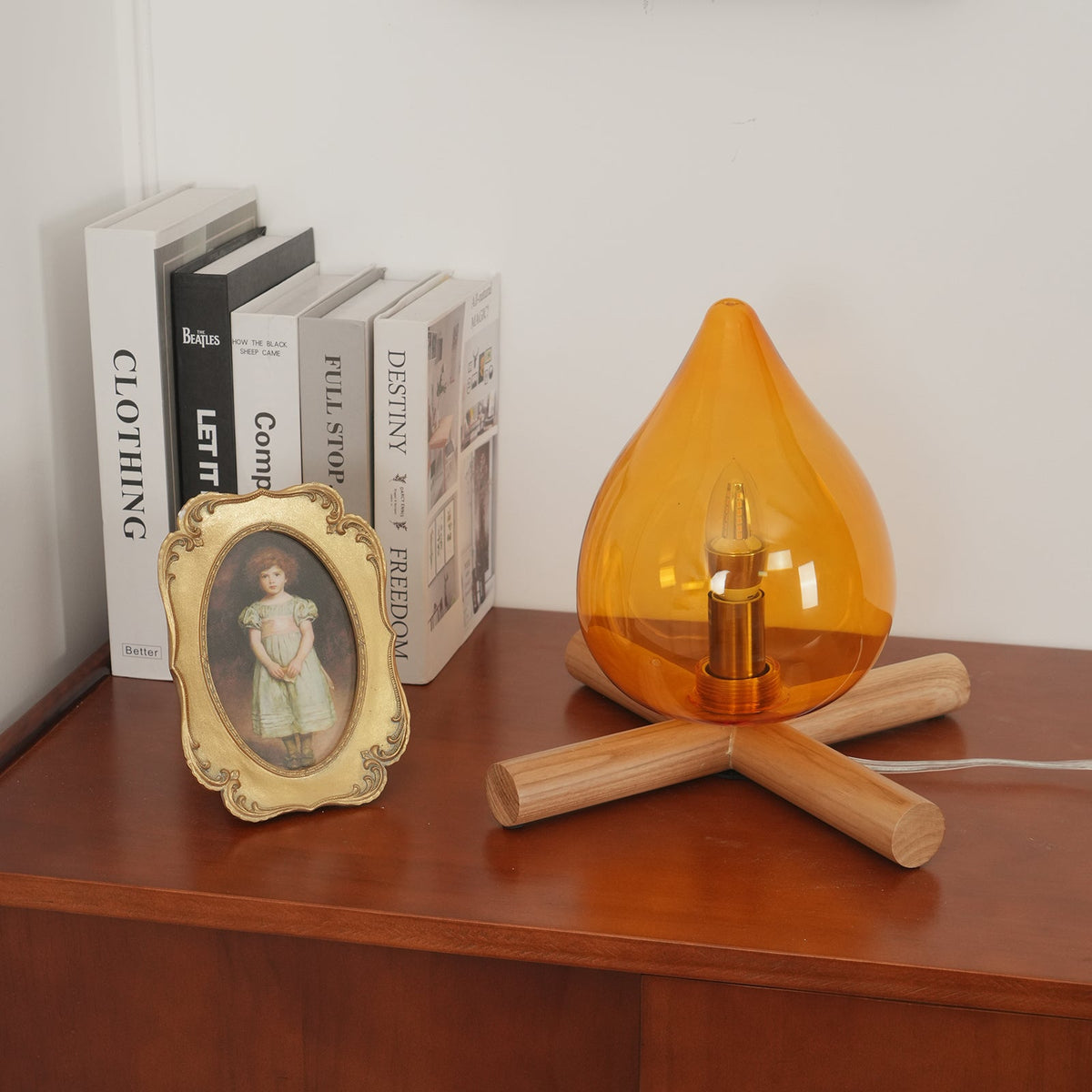 Orange flame-shaped glass table lamp with solid wood cross base 3