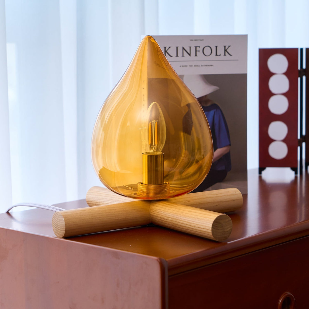 Orange flame-shaped glass table lamp with solid wood cross base 40