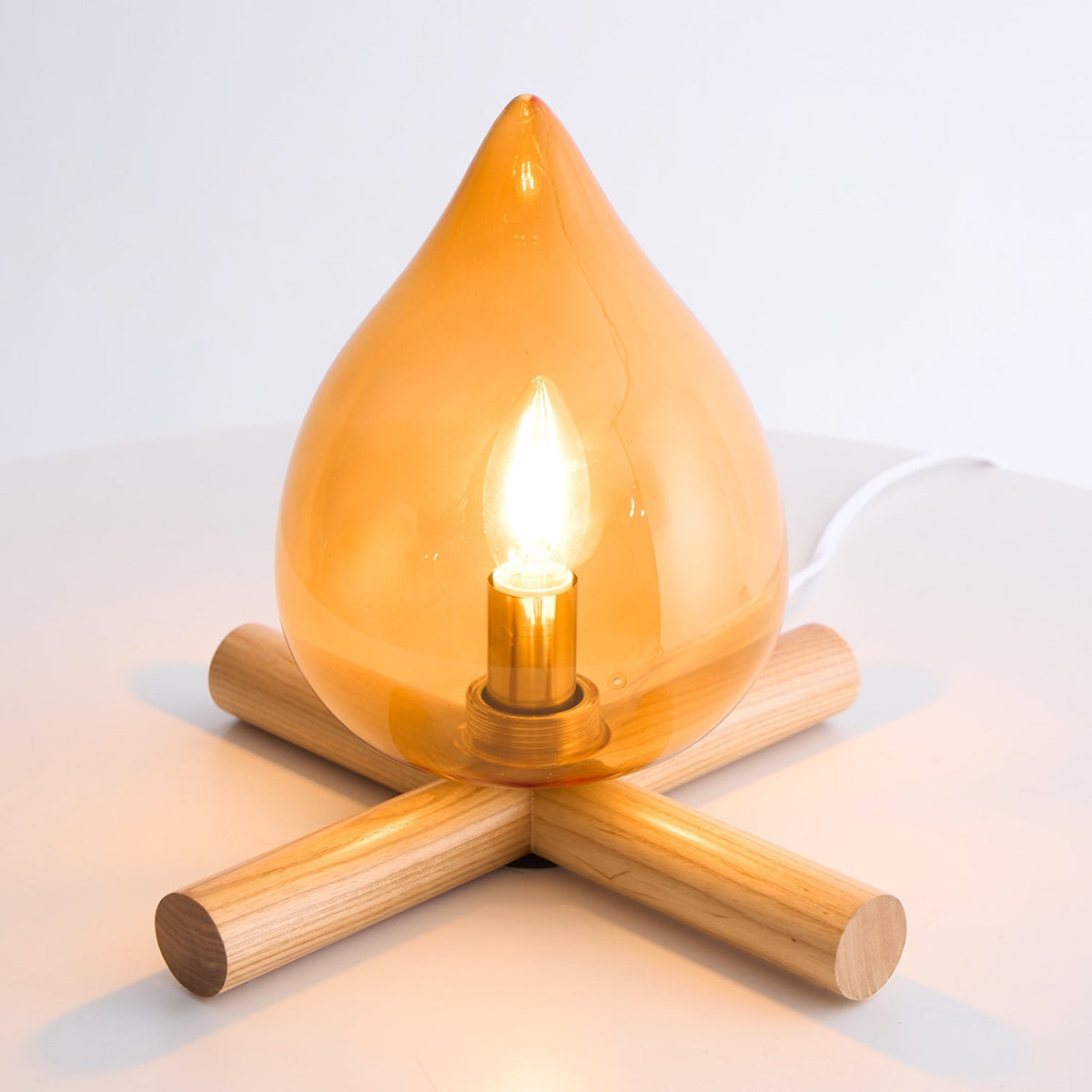 Orange flame-shaped glass table lamp with solid wood cross base 45