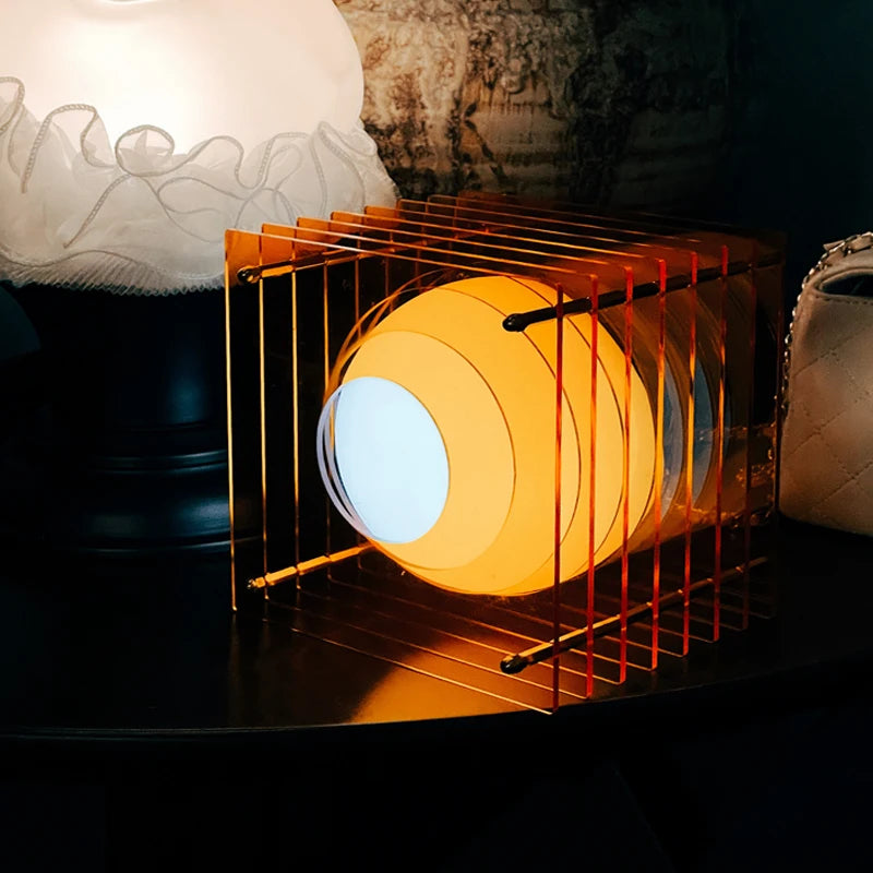 Orange acrylic cube LED table lamp illuminated indoors