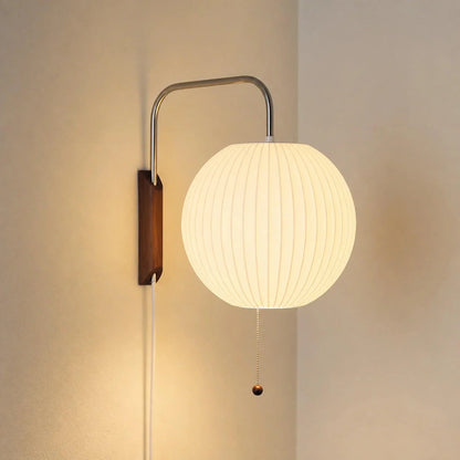 Glowing ribbed globe wall light with curved arm