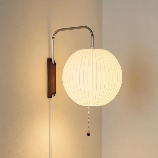 Glowing ribbed globe wall light with curved arm