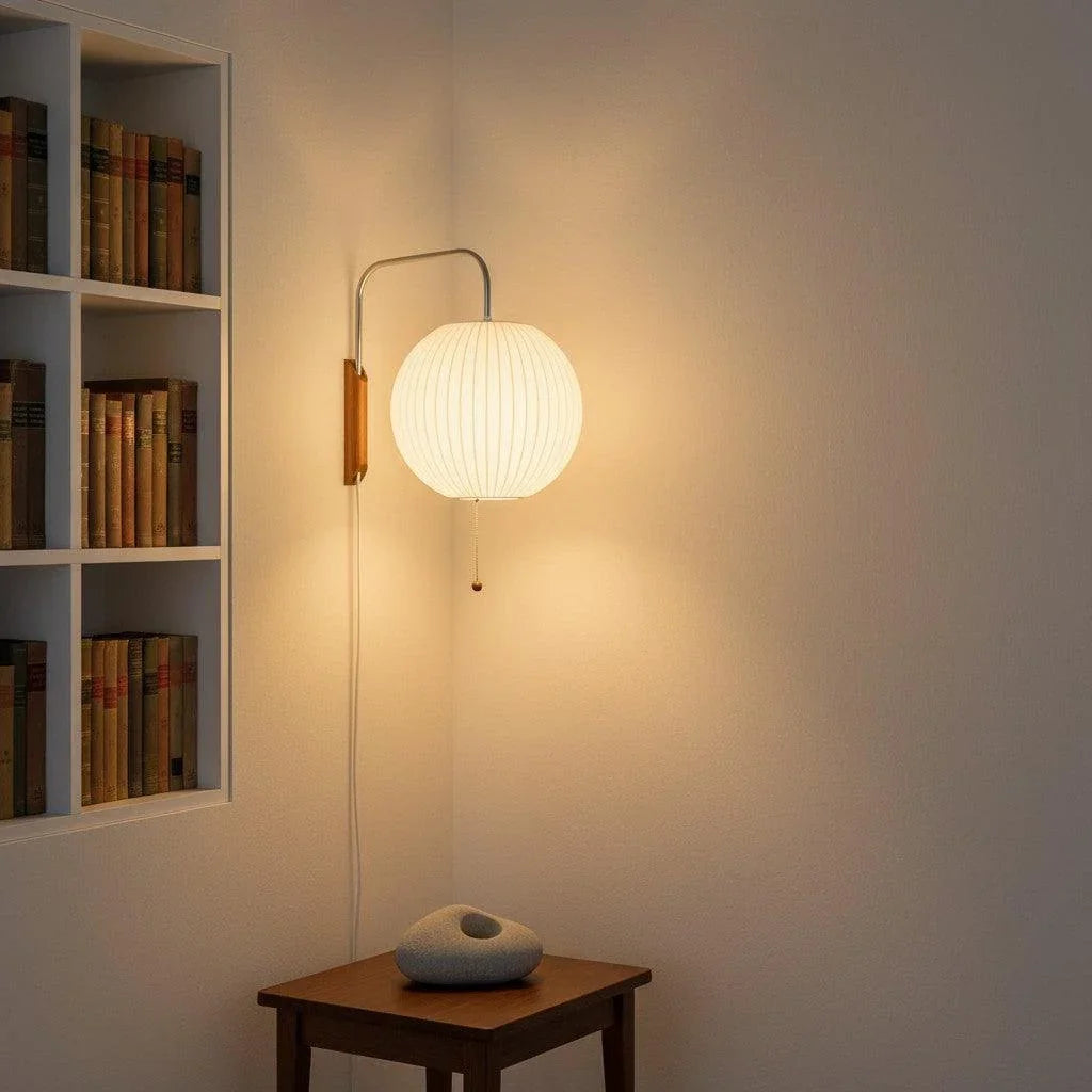 Ribbed globe wall light beside shelving