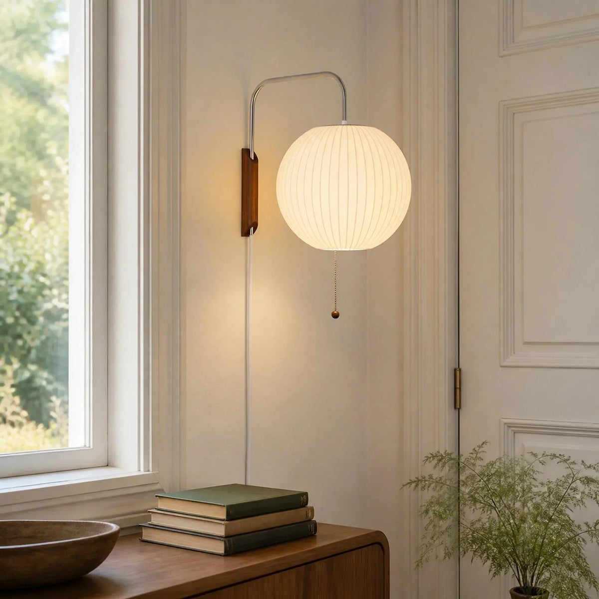 Round ribbed wall light beside a window