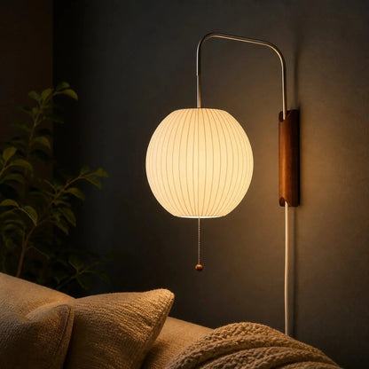 Glowing ribbed globe wall light over a sofa