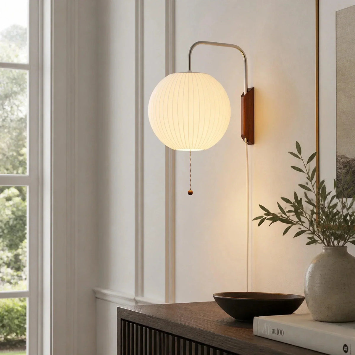 Ribbed globe wall sconce above a console