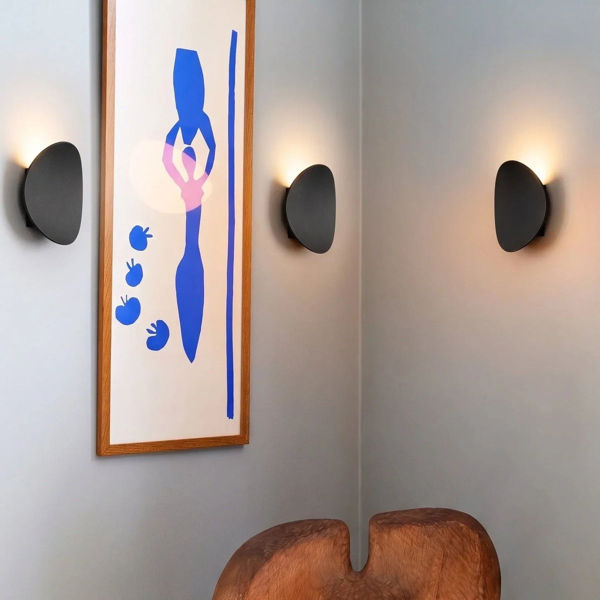 Black pebble halo wall lights beside artwork