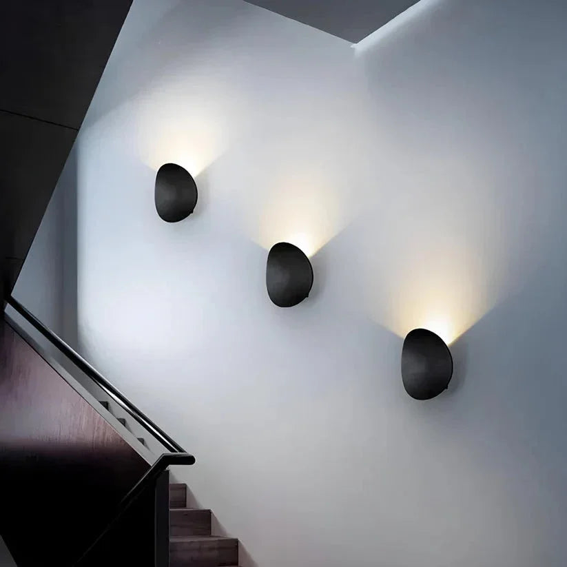 Pebble wall lights along a staircase