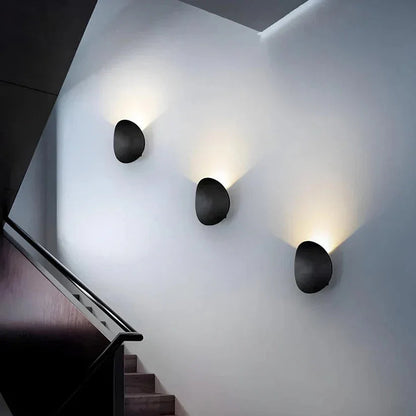 Pebble wall lights along a staircase