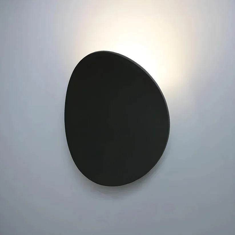 Close-up of black pebble wall light and halo