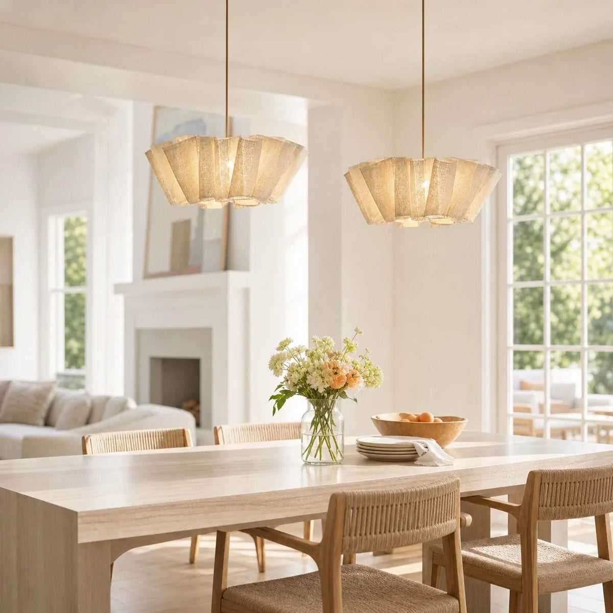 Two pleated fabric pendants above a dining table
