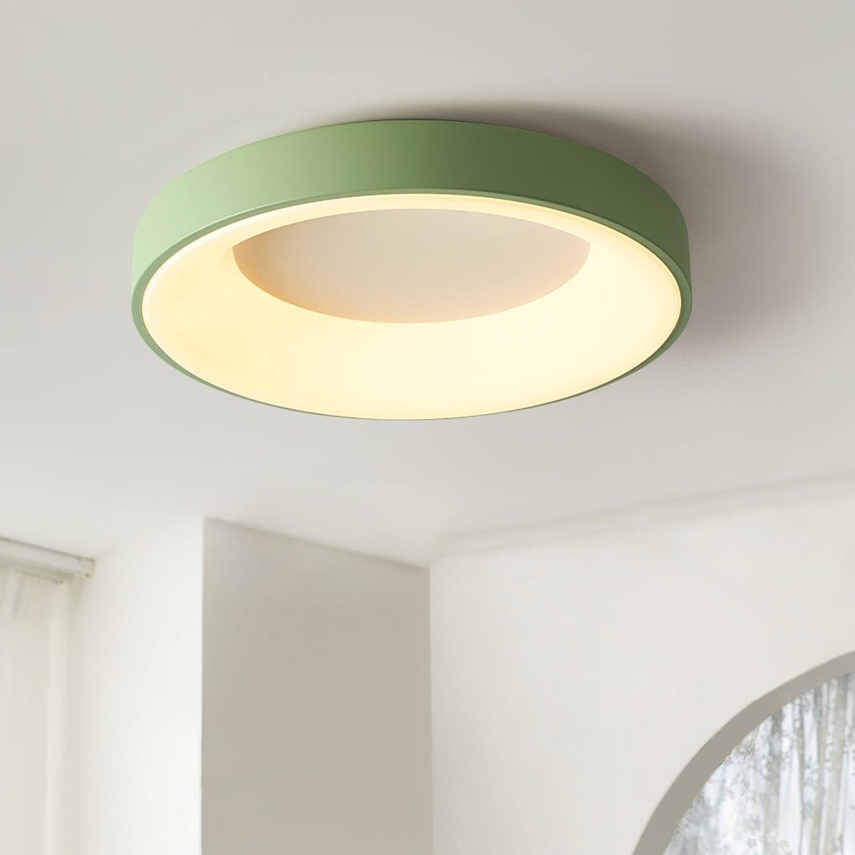 Green recessed-ring LED flush ceiling light mounted on a ceiling
