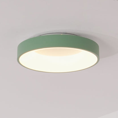 Green recessed-ring LED flush ceiling light mounted on a ceiling