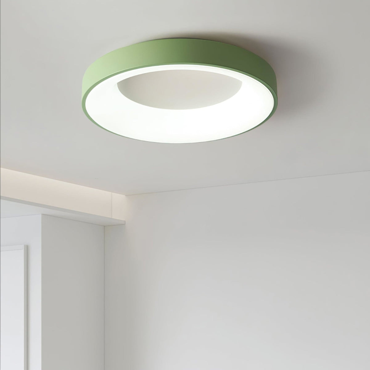 Green recessed-ring LED flush ceiling light mounted on a ceiling