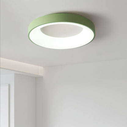 Green recessed-ring LED flush ceiling light mounted on a ceiling