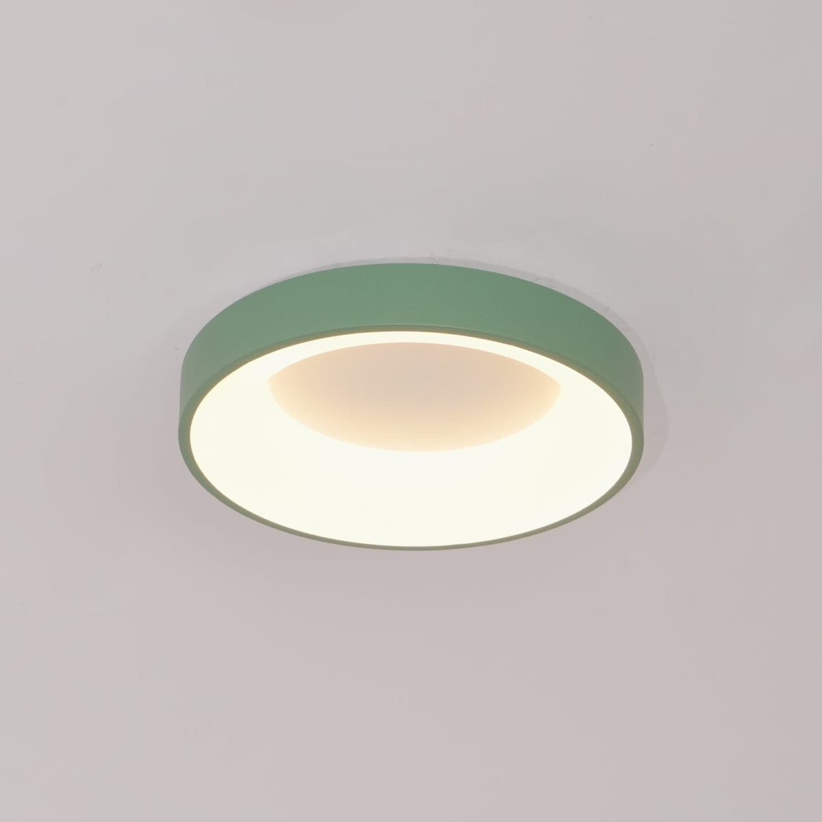 Green recessed-ring LED flush ceiling light mounted on a ceiling