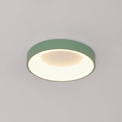 Green recessed-ring LED flush ceiling light mounted on a ceiling