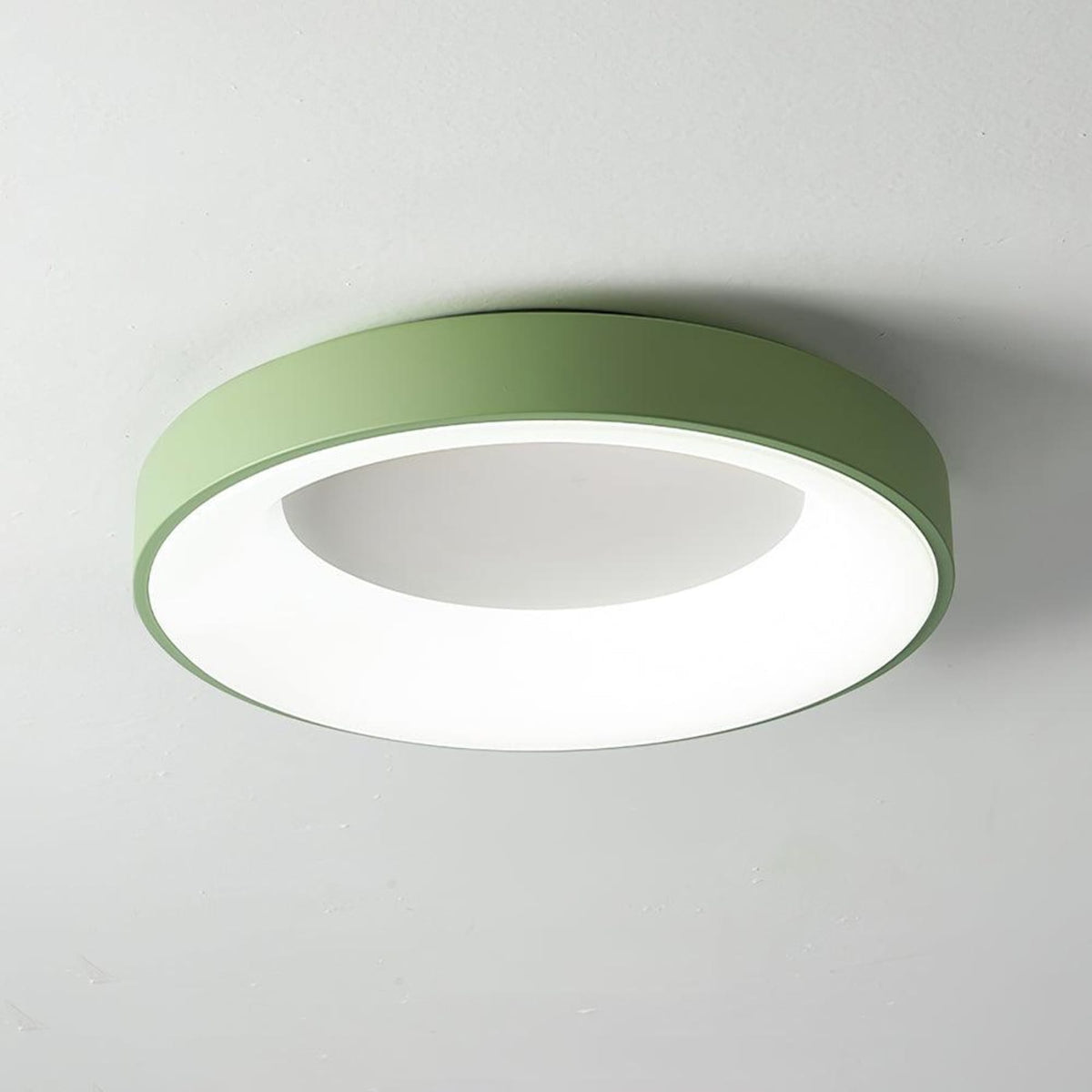 Green recessed-ring LED flush ceiling light mounted on a ceiling