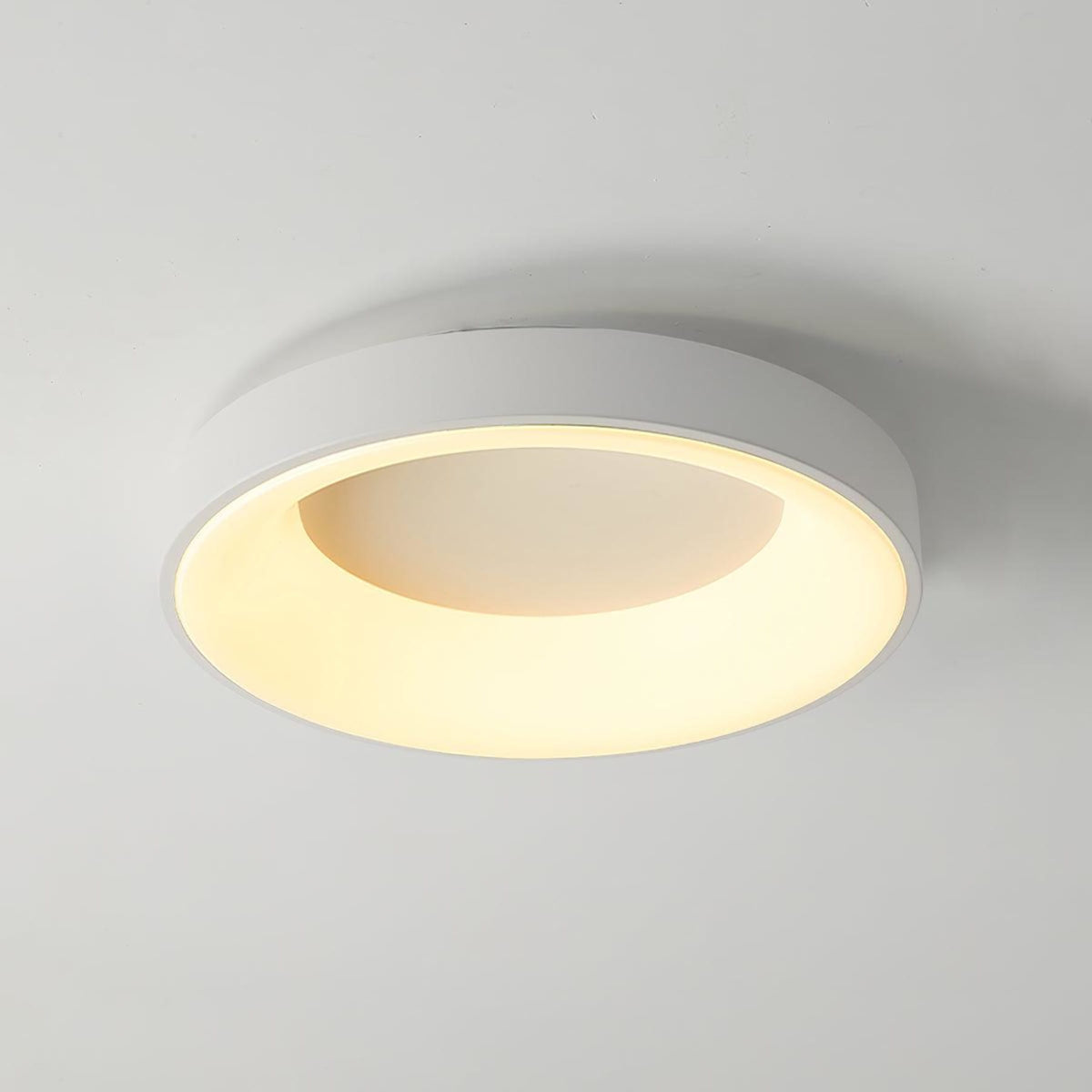White recessed-ring LED flush ceiling light mounted on a ceiling
