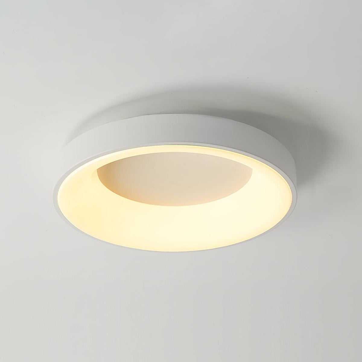 White recessed-ring LED flush ceiling light mounted on a ceiling