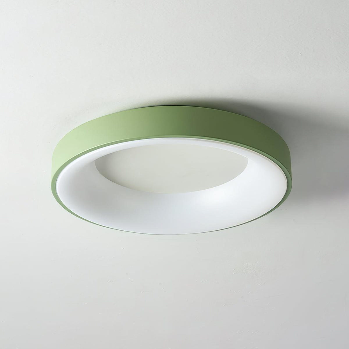 Green recessed-ring LED flush ceiling light mounted on a ceiling