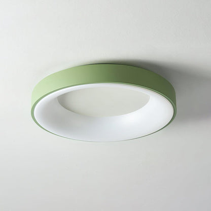 Green recessed-ring LED flush ceiling light mounted on a ceiling