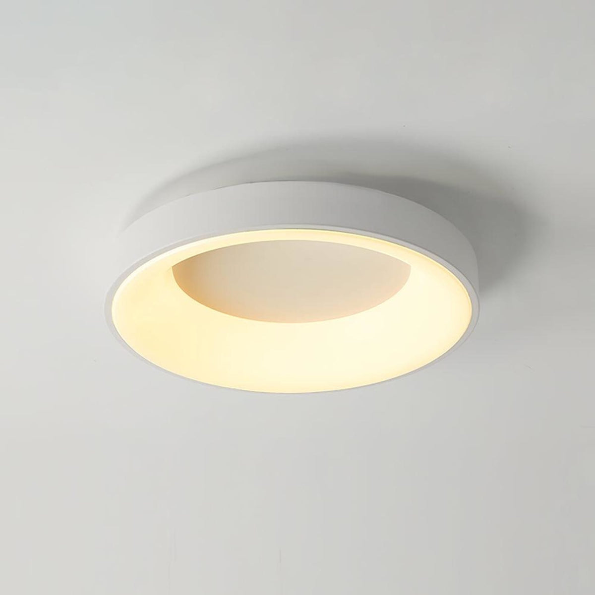 White recessed-ring LED flush ceiling light mounted on a ceiling
