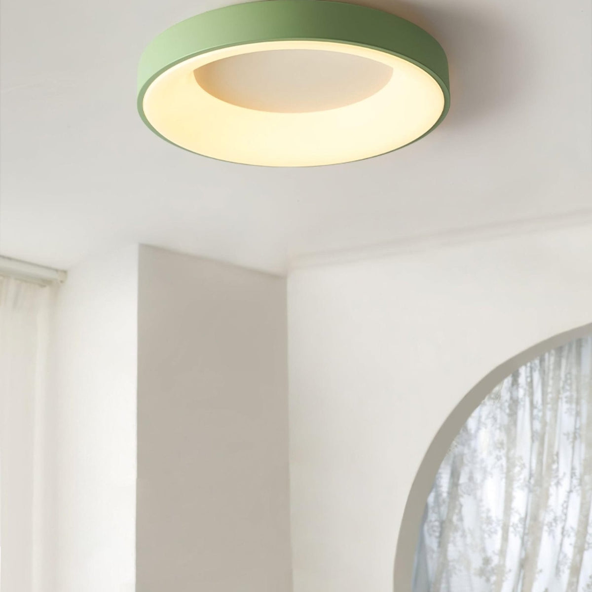 Green recessed-ring LED flush ceiling light mounted on a ceiling