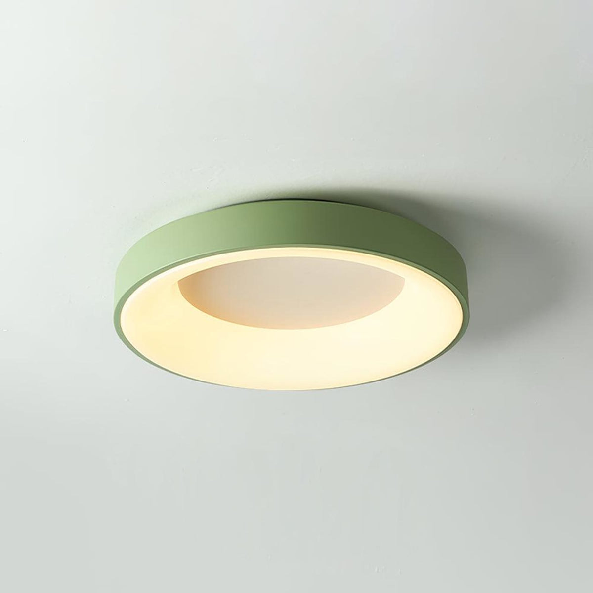 Green recessed-ring LED flush ceiling light mounted on a ceiling