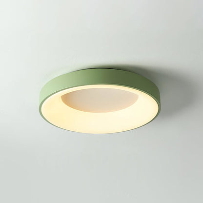 Green recessed-ring LED flush ceiling light mounted on a ceiling