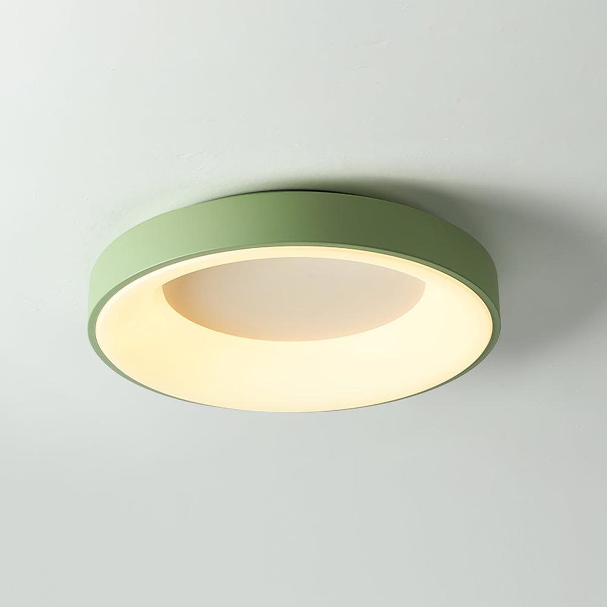 Green recessed-ring LED flush ceiling light mounted on a ceiling